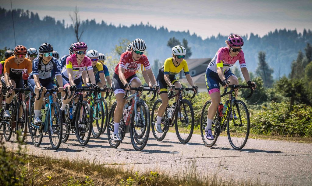 Women road racers riding in the peloton