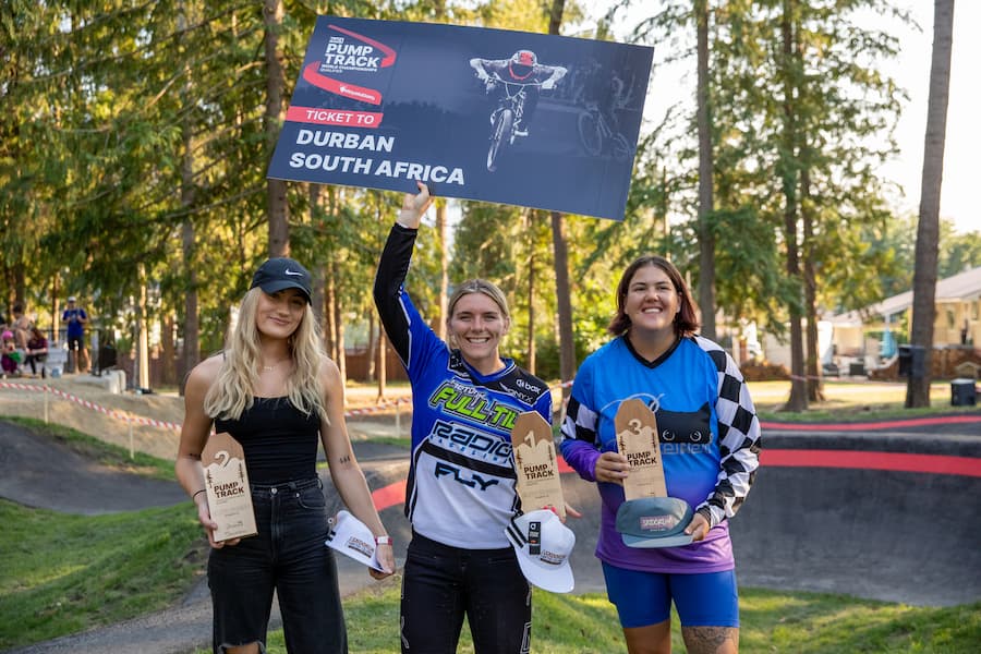 Three women posing with their trophies.