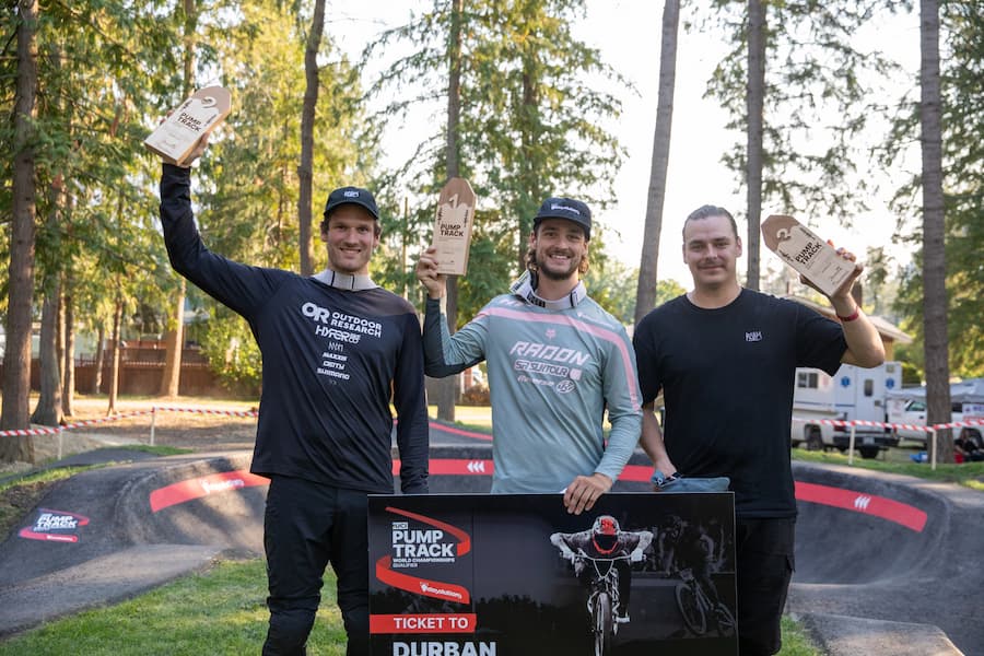 Three riders standing with their trophies.