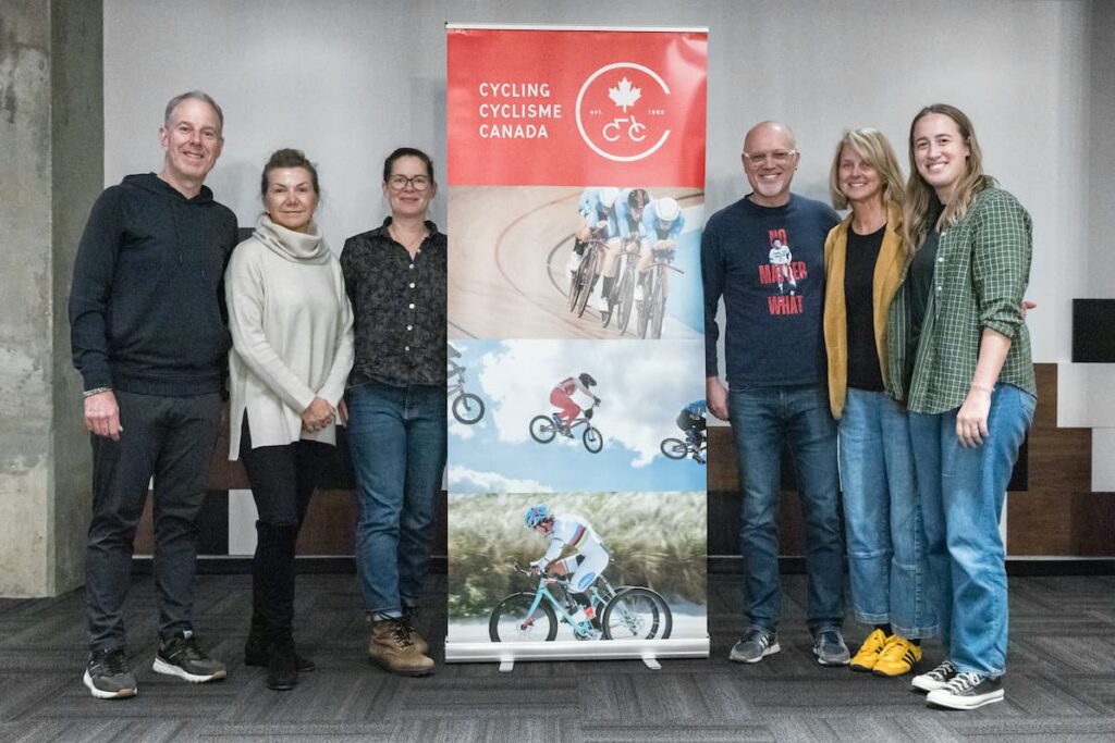 Group of people standing beside Cycling Canada banner.