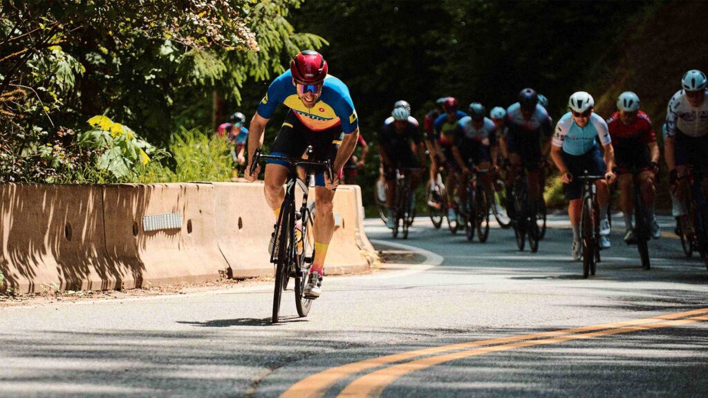 Road cyclist breaking away from the peloton on the road