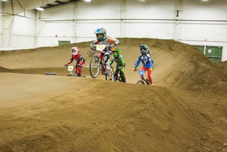 Youth ride the indoor track at Abbotsford BMX. Photo by Jules Chalmers-Owega.